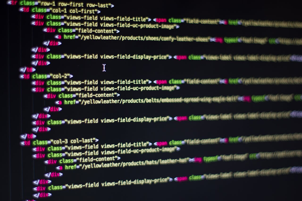 Choosing the Right Path for Your Website: WordPress or Custom Development? Detailed close-up of HTML code on a computer monitor, showcasing web development.